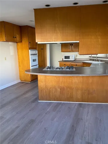 a view of a kitchen with wooden floor