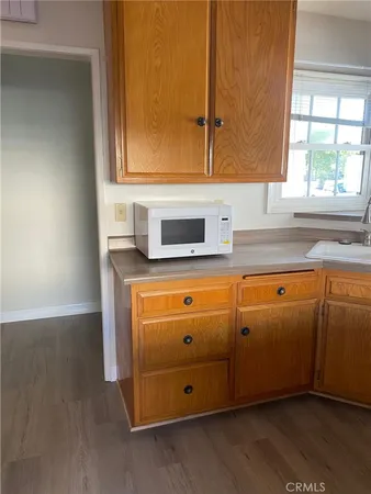 a kitchen with granite countertop a sink and a window