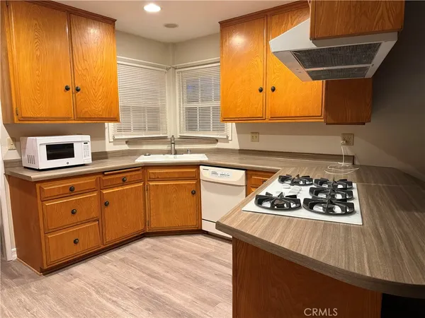 a kitchen with stainless steel appliances granite countertop a sink and a stove