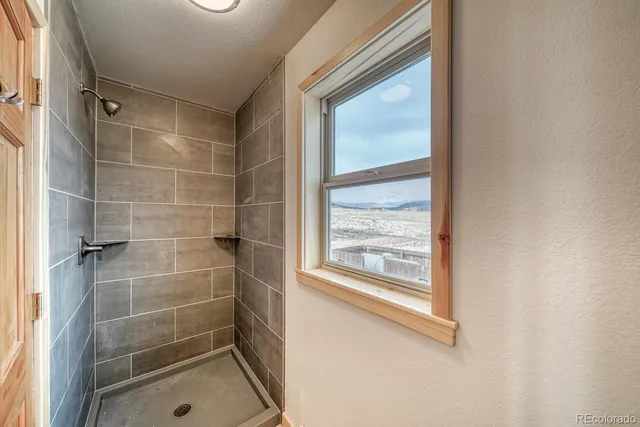 a bathroom with a glass shower door