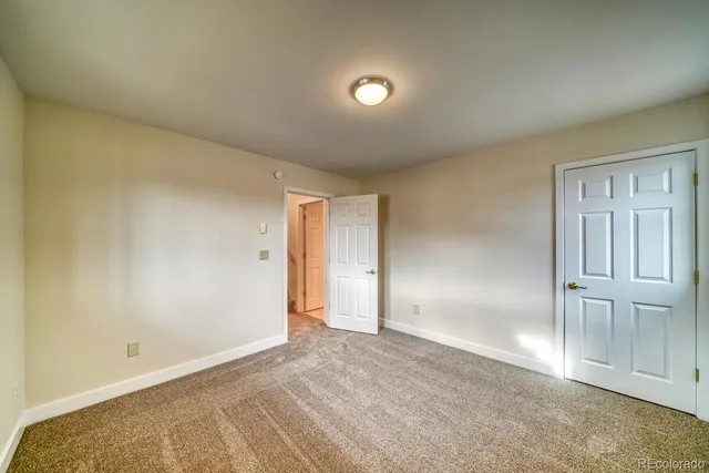 an empty room with windows and closet