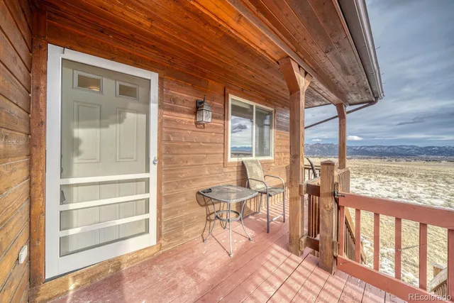 a view of a chairs and table in the balcony