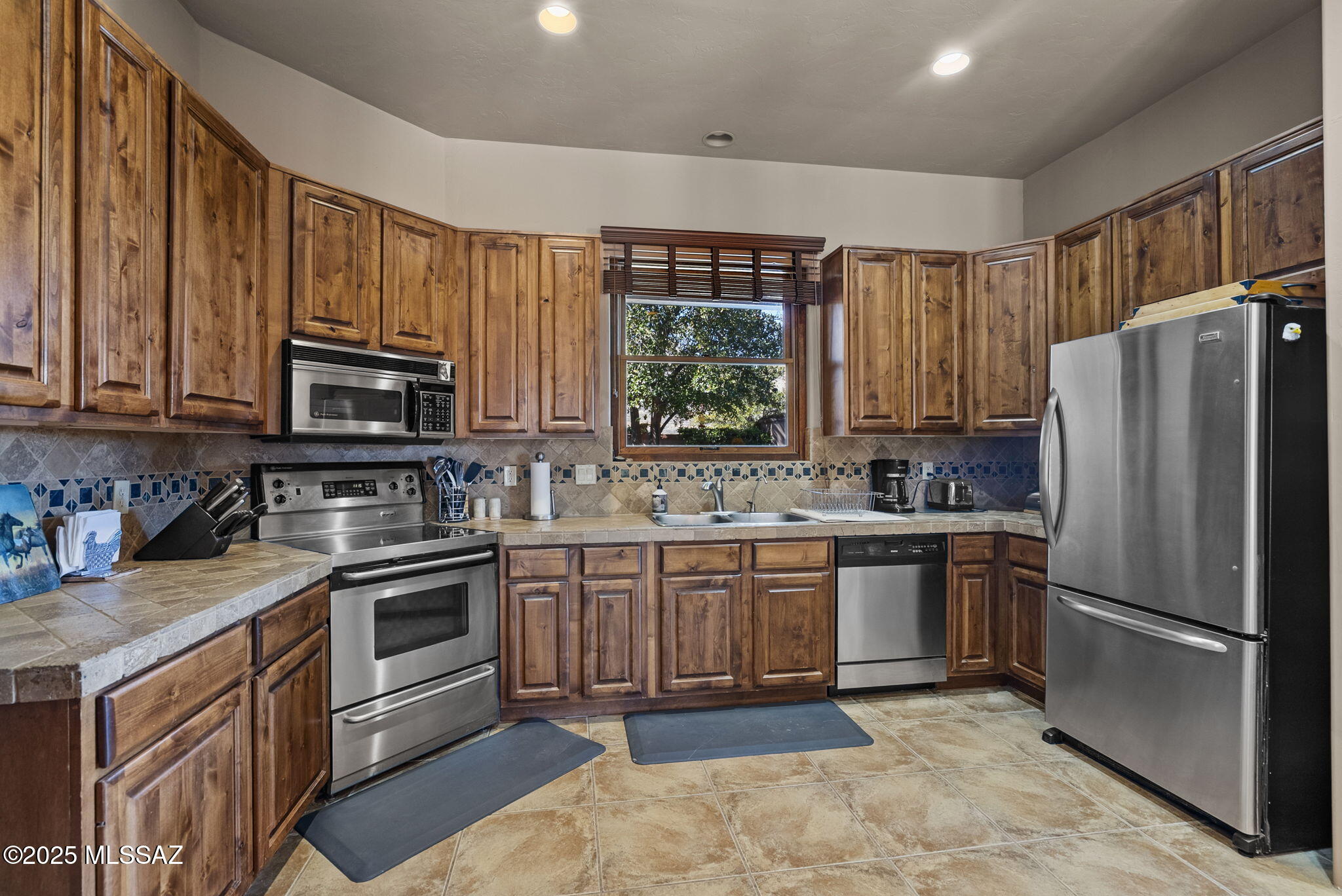 1265 Morning Star Drive Rio Rico, AZ 85648 - Photo 16 of 50 a kitchen with stainless steel appliances granite countertop a refrigerator stove and sink