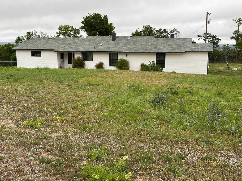 2078 Lower Crabapple Road Fredericksburg, TX 78624 - Photo 1 of 44 a front view of a house with garden