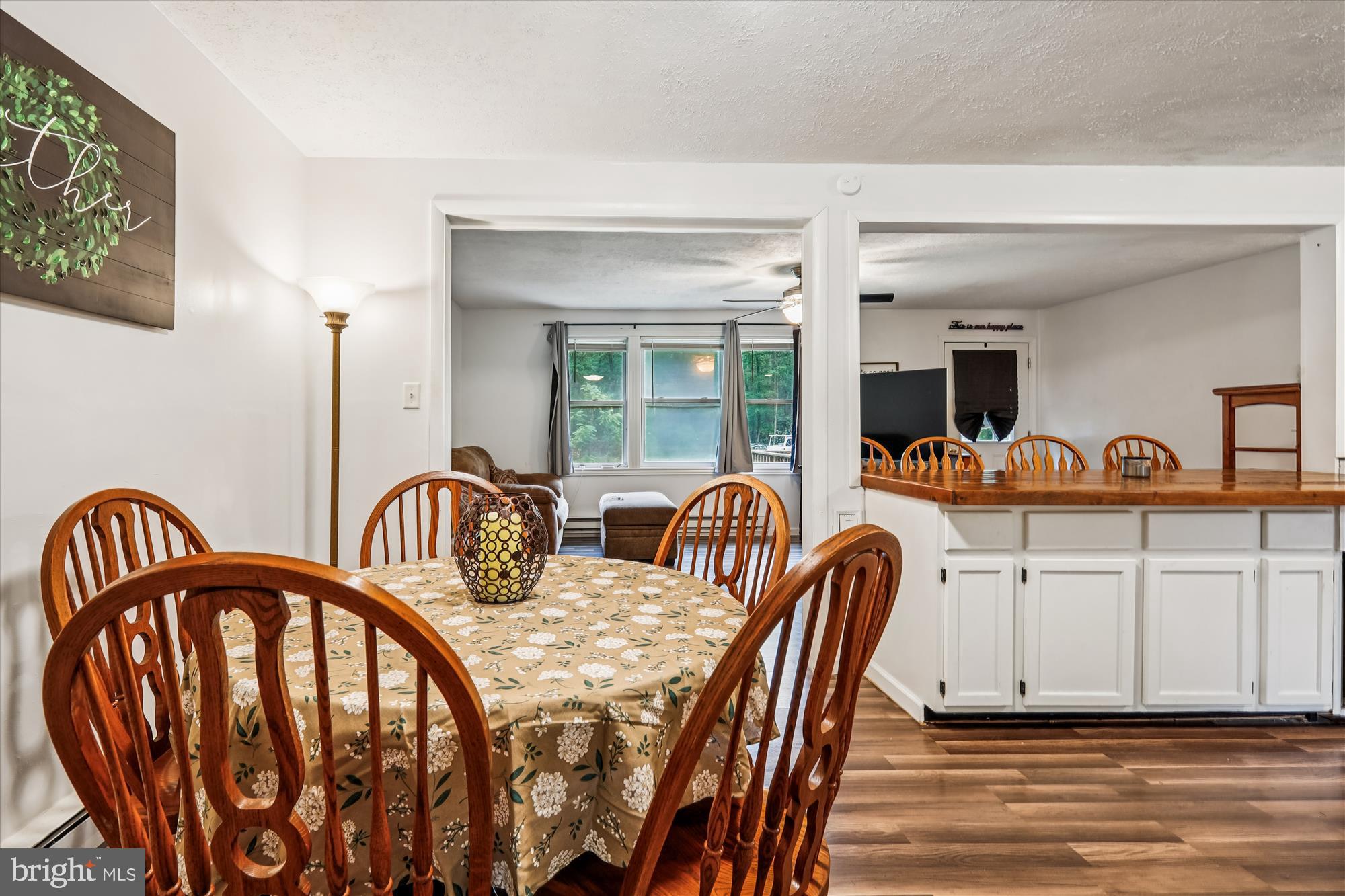 26623 Bee Tree Road Henderson, MD 21640 - Photo 11 of 33 a group of chairs sitting in a kitchen next to a window