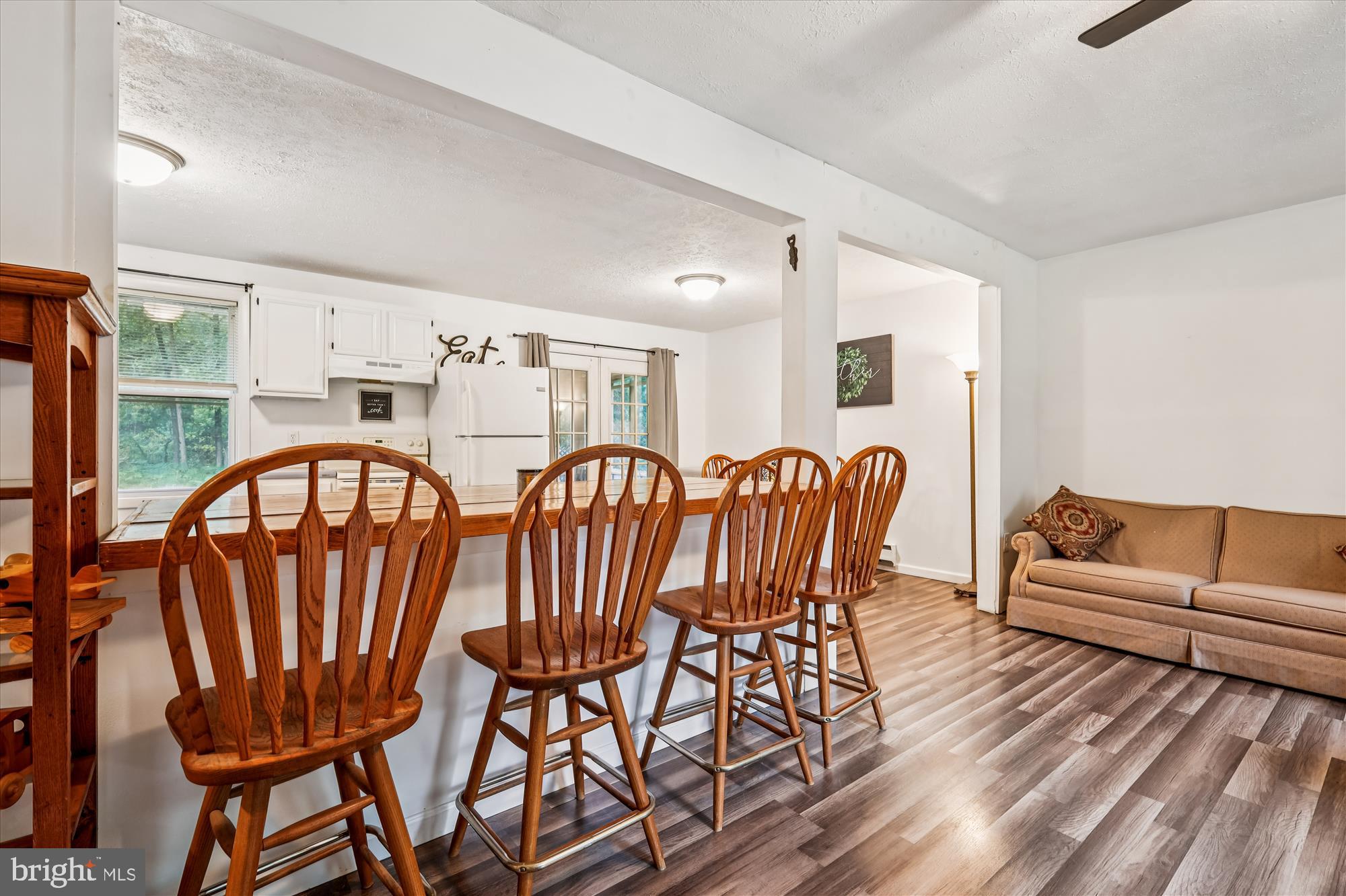 26623 Bee Tree Road Henderson, MD 21640 - Photo 12 of 33 a view of a dining room with furniture a rug and wooden floor