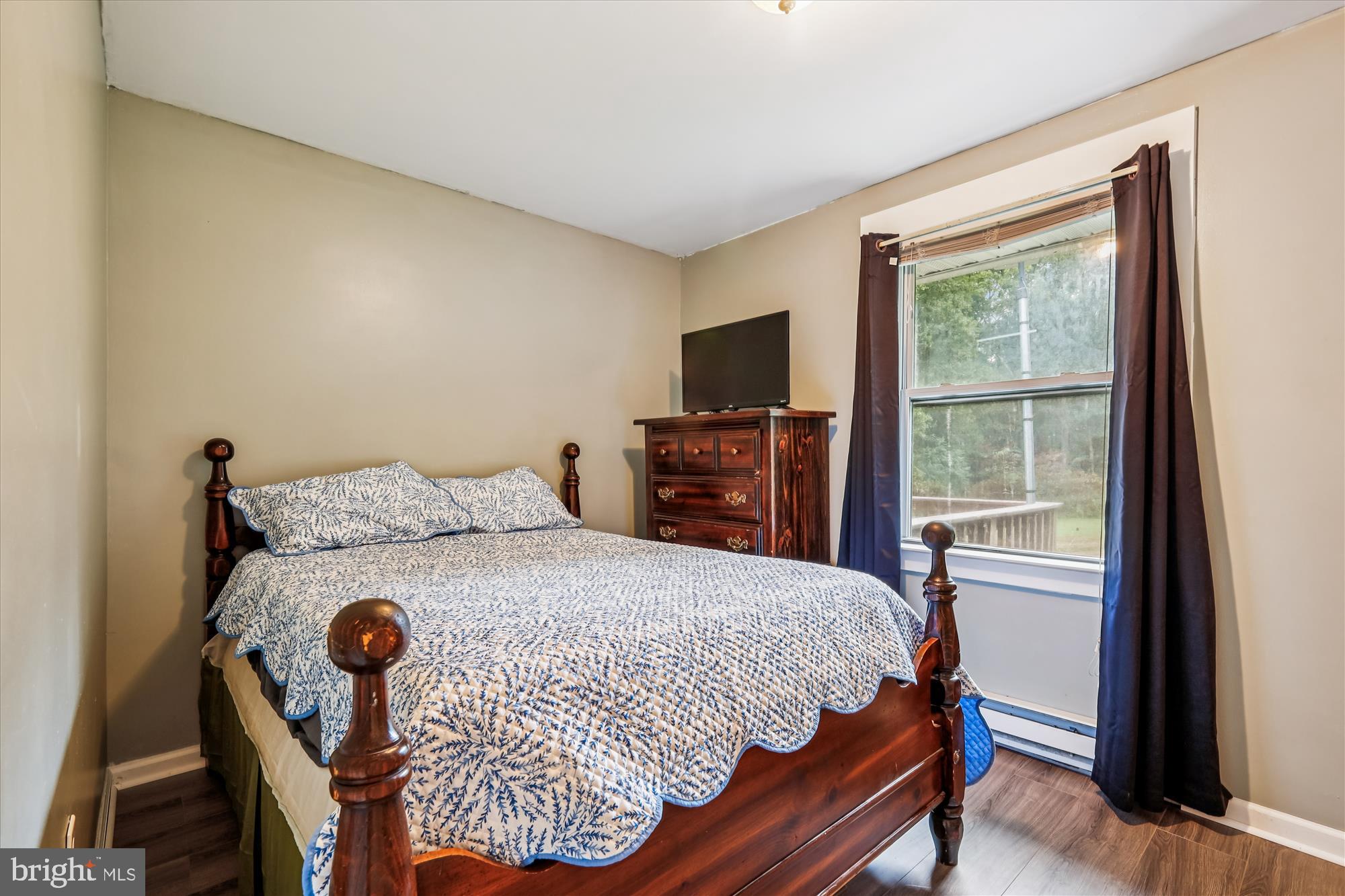 26623 Bee Tree Road Henderson, MD 21640 - Photo 17 of 33 a bedroom with a bed and a flat tv screen on the dresser