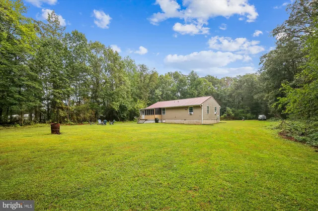 a front view of a house with a big yard