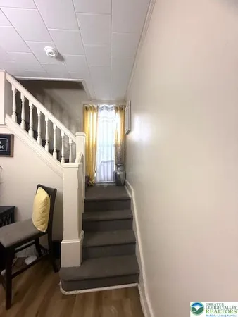 a view of entryway and hall with wooden floor