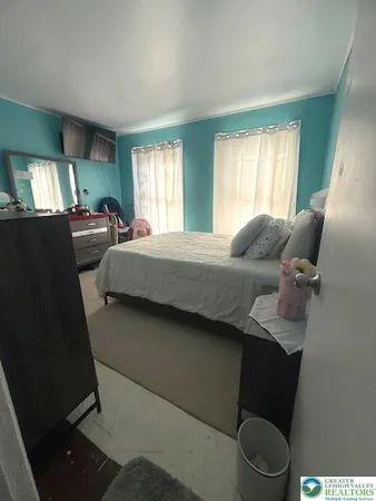 a bedroom with furniture and a flat screen tv