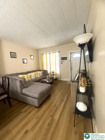 a living room with furniture and a dining table