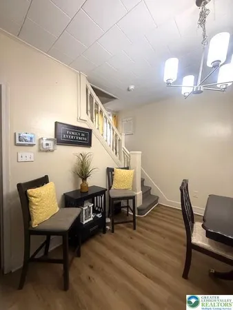 a view of a room with furniture and wooden floor