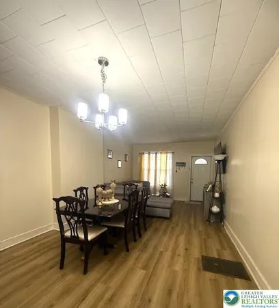 a living room with furniture and a chandelier