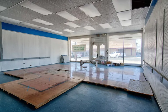 a living room with furniture pool table and windows