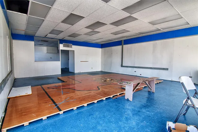 a room with wooden floor and furniture