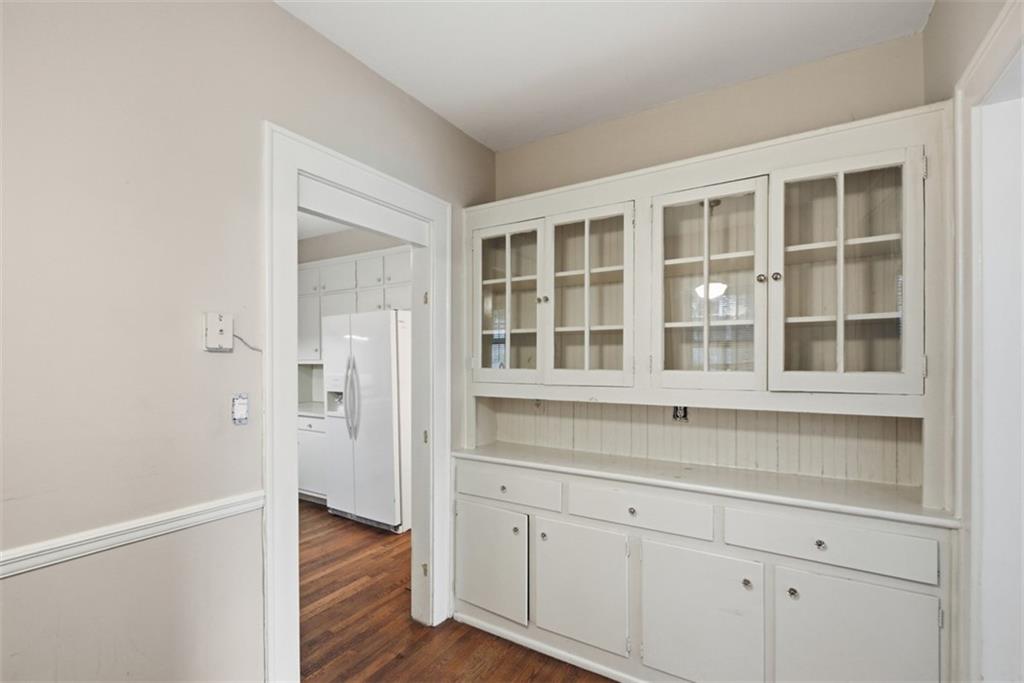 1424 Emory Road Northeast Atlanta, GA 30306 - Photo 12 of 36 a hallway with white cabinets and wooden floors