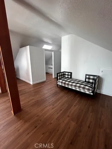 a view of room with wooden floor and stairs