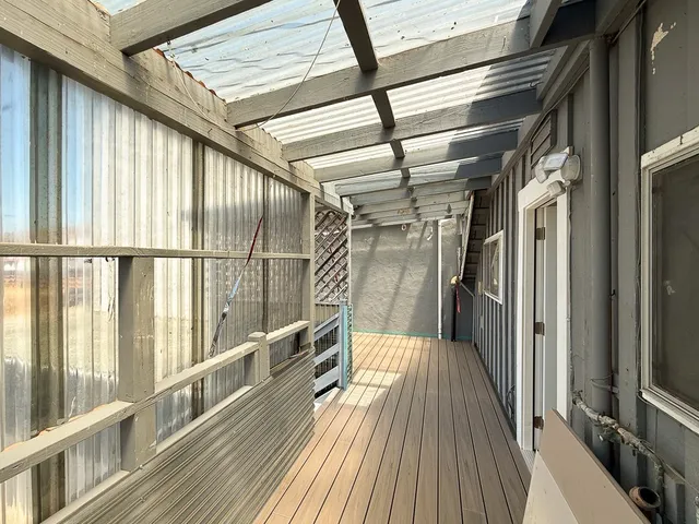 a view of hallway with wooden floor