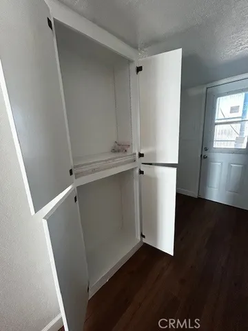 a view of closet with wooden floor