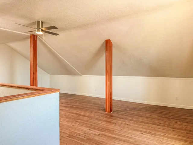 a view of a room with wooden floor