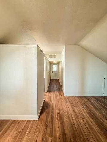 a view of a room with wooden floor