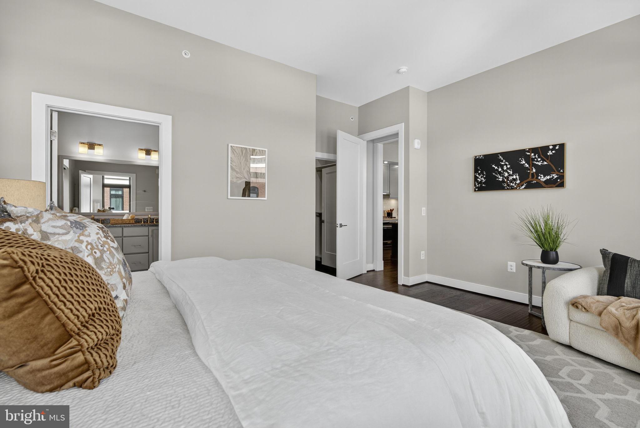 3 Stationmaster Street Southeast, Unit 402 Leesburg, VA 20175 - Photo 13 of 46 a bedroom with a bed and glass walk in closet