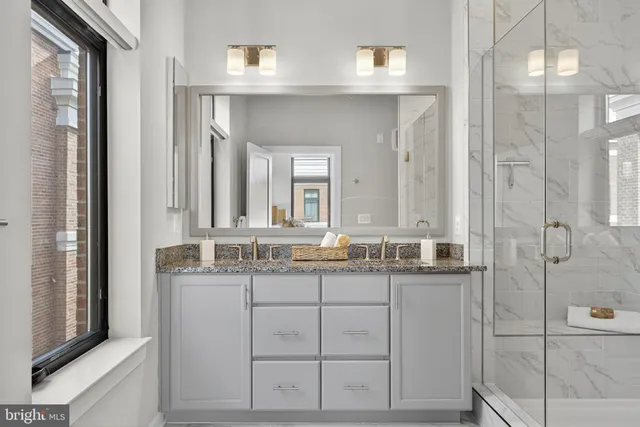 a bedroom with a bed and glass walk in closet