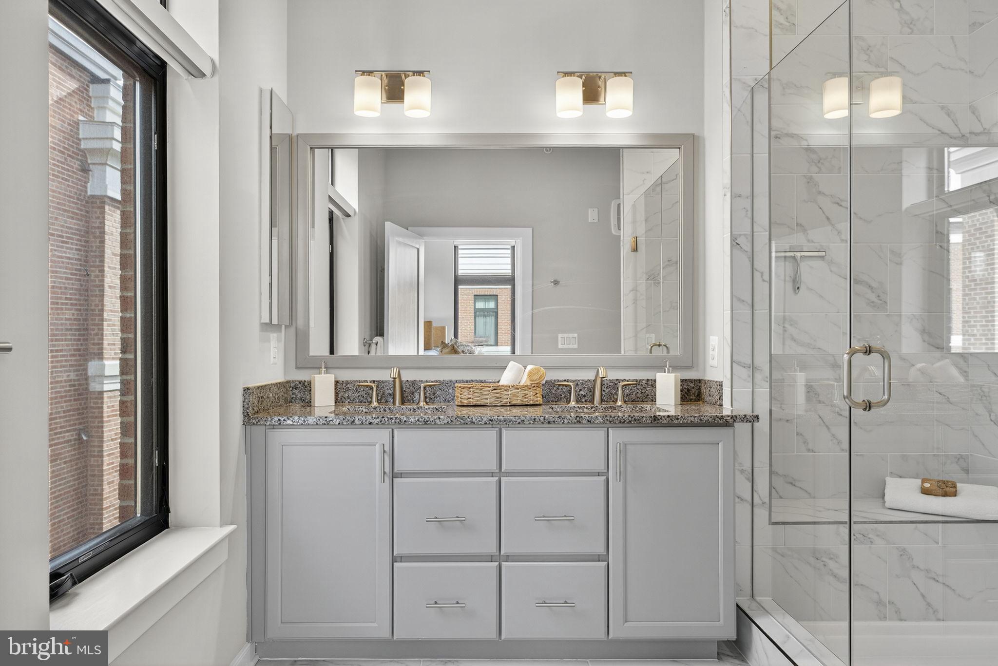 3 Stationmaster Street Southeast, Unit 402 Leesburg, VA 20175 - Photo 15 of 46 a bathroom with a granite countertop sink and a mirror