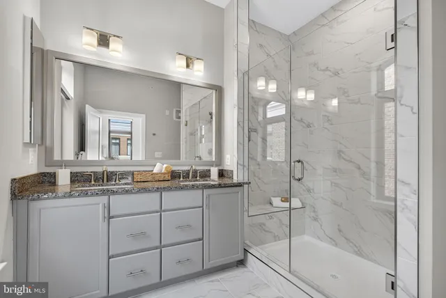 a bathroom with a double vanity sink a mirror a bathtub and shower