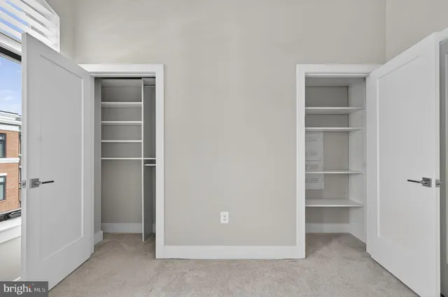 a spacious bedroom with a bed and window