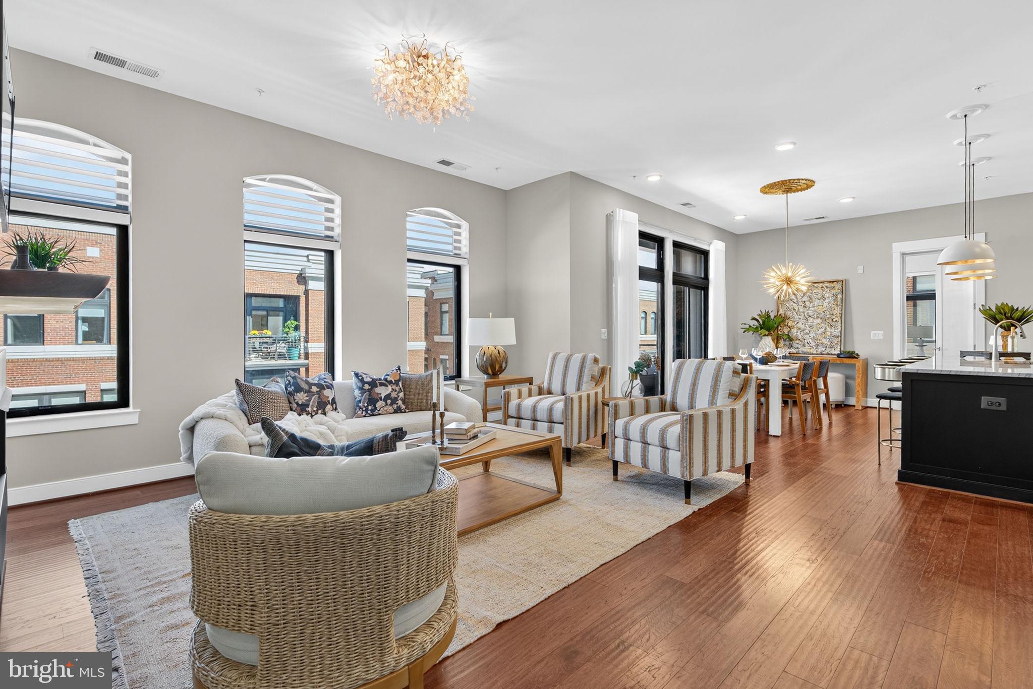 3 Stationmaster Street Southeast, Unit 402 Leesburg, VA 20175 - Photo 2 of 46 a living room with furniture and wooden floor