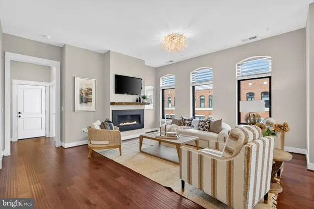 a living room with furniture and wooden floor