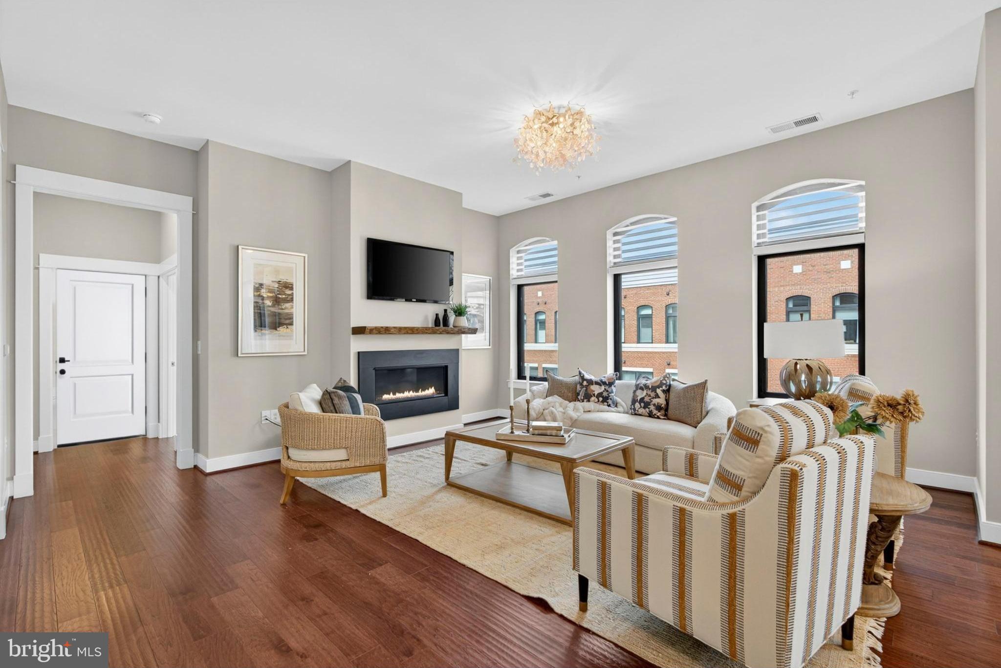 3 Stationmaster Street Southeast, Unit 402 Leesburg, VA 20175 - Photo 3 of 46 a living room with furniture fireplace and a flat screen tv