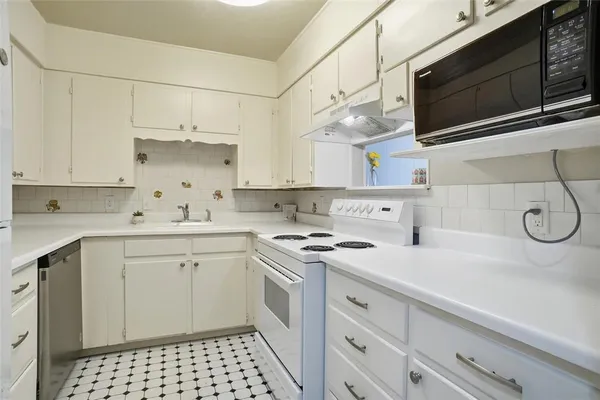 a kitchen with a sink stove and microwave