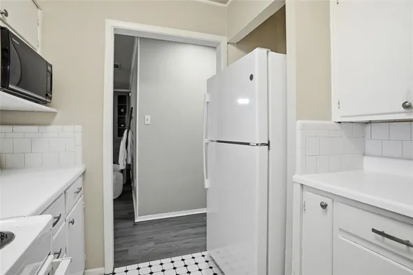 a view of a kitchen from the hallway