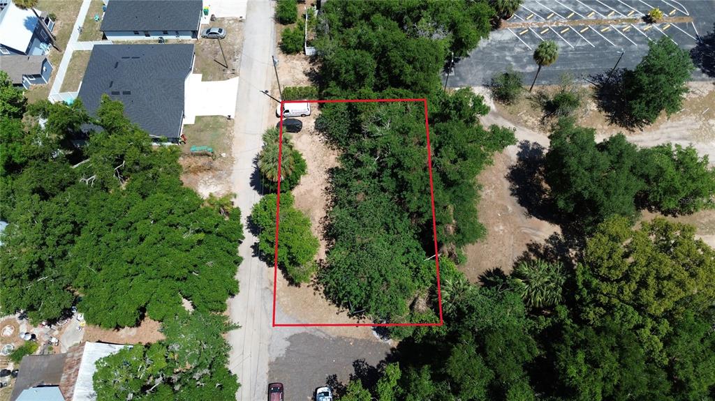 an aerial view of residential house with outdoor space and trees all around