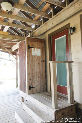 955 Faurie Road, Unit TINY HOUSE Lakehills, TX 78063 - Photo 16 of 23 a view of an entrance door of the house