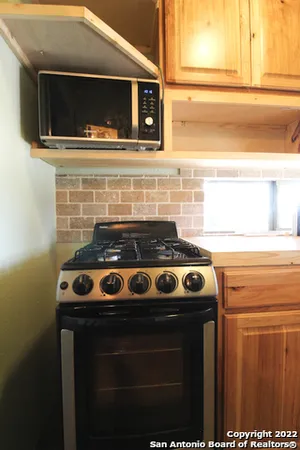 a stove top oven sitting inside of a kitchen