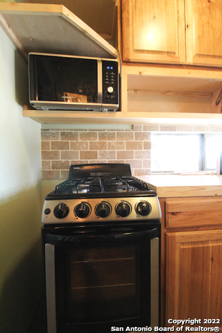 955 Faurie Road, Unit TINY HOUSE Lakehills, TX 78063 - Photo 5 of 23 a stove top oven sitting inside of a kitchen