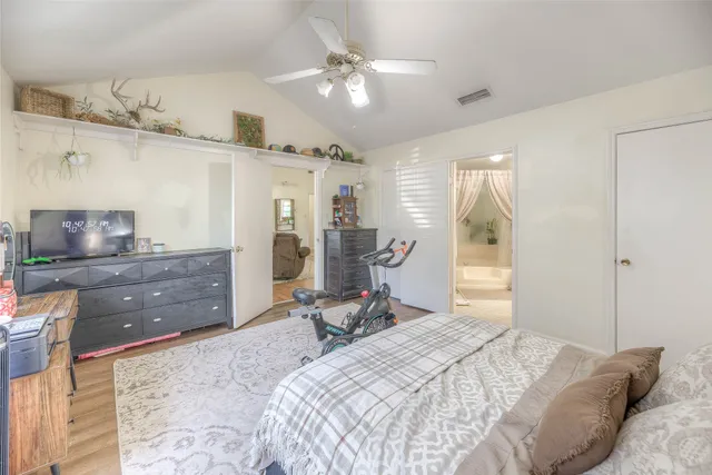 a bedroom with furniture and a chandelier
