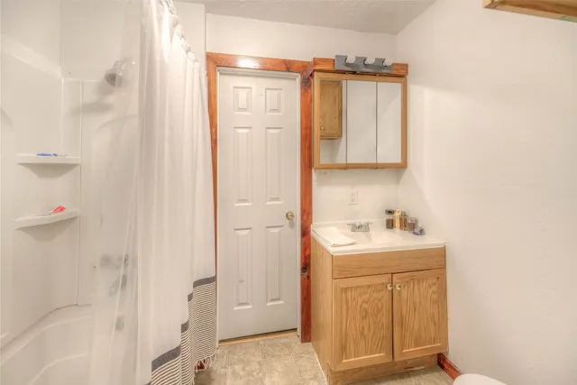 a living room with lots of furniture and clutter