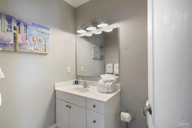 a bathroom with a sink mirror and vanity