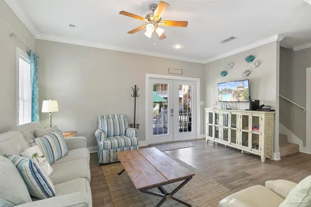 a living room with furniture and wooden floor