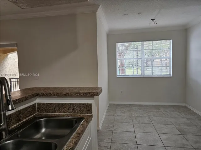 a view of a kitchen with a sink dishwasher and a stove