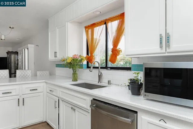 a kitchen with a sink and large window