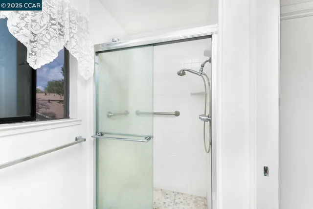 a view of a patio with a table chairs potted plants and palm trees