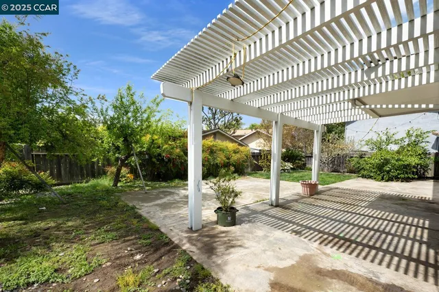 a backyard of a house with table and chairs