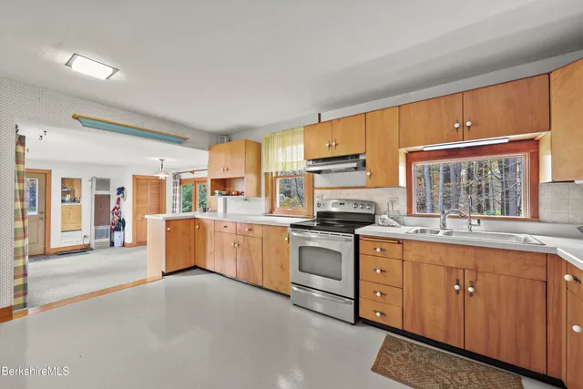 a kitchen with a sink refrigerator and cabinets