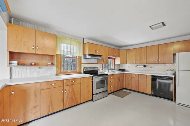 a view of a livingroom with furniture and a window