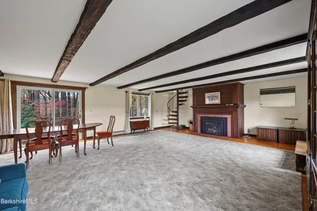 an empty room with fireplace and window